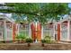 Charming townhome features classic brick facade, white columns, balconies, and beautifully landscaped courtyard at 872 Briarcliff Ne Rd # B2, Atlanta, GA 30306