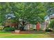 Apartment building front entrance with mature trees and manicured lawns at 872 Briarcliff Ne Rd # B2, Atlanta, GA 30306