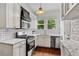 Bright kitchen featuring white cabinets, subway tile backsplash, marble counters and stainless steel appliances at 872 Briarcliff Ne Rd # B2, Atlanta, GA 30306