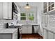 Modern kitchen features white cabinetry, stainless steel appliances, and tile backsplash at 872 Briarcliff Ne Rd # B2, Atlanta, GA 30306
