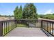 View of the stained wood back deck, perfect for enjoying a lovely day under a clear sky at 113 Garden Walk, Stockbridge, GA 30281
