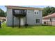 Exterior view of the home's backyard and black wooden deck, highlighting the well-maintained lawn at 113 Garden Walk, Stockbridge, GA 30281