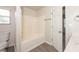 Bright bathroom featuring a tub, shower with white tile surround, and wood-look vinyl flooring at 113 Garden Walk, Stockbridge, GA 30281