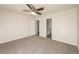 Spacious bedroom with neutral tones, plush carpet, and a ceiling fan with light fixture at 113 Garden Walk, Stockbridge, GA 30281