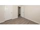 Bedroom featuring wood-look vinyl flooring and an open doorway at 113 Garden Walk, Stockbridge, GA 30281
