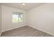 Bedroom featuring wood-look vinyl flooring and a window with blinds at 113 Garden Walk, Stockbridge, GA 30281