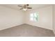 Neutral bedroom showcasing modern ceiling fan, plush carpeting, and lots of natural light at 113 Garden Walk, Stockbridge, GA 30281