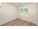 Cozy dining area featuring a modern light fixture and a large window with natural light at 113 Garden Walk, Stockbridge, GA 30281