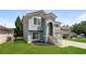 Attractive home featuring a stone staircase, a well-kept lawn, and a stucco facade at 113 Garden Walk, Stockbridge, GA 30281