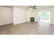 Bright living room featuring a fireplace, modern ceiling fan, and sliding glass doors at 113 Garden Walk, Stockbridge, GA 30281