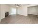 Bright living room featuring a fireplace, modern ceiling fan, and sliding glass doors at 113 Garden Walk, Stockbridge, GA 30281
