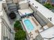 Aerial view of a condo courtyard with a sparkling pool, sun loungers, and lush landscaping for a resort-like experience at 384 Ralph Mcgill Ne Blvd # 123, Atlanta, GA 30312