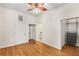 Bright bedroom featuring hardwood floors, a ceiling fan, closet and laundry room access at 384 Ralph Mcgill Ne Blvd # 123, Atlanta, GA 30312