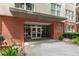 Exterior shot of the Central City Condominium entrance at 384 with brick and glass doors at 384 Ralph Mcgill Ne Blvd # 123, Atlanta, GA 30312
