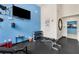 Condo gym featuring weights, TV, and machines in a blue-accented space, perfect for a full-body workout at 384 Ralph Mcgill Ne Blvd # 123, Atlanta, GA 30312