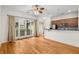 Sun-filled living room features hardwood floors, ceiling fan, and access to the balcony at 384 Ralph Mcgill Ne Blvd # 123, Atlanta, GA 30312