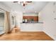 Open living room with hardwood floors flows into kitchen with breakfast bar at 384 Ralph Mcgill Ne Blvd # 123, Atlanta, GA 30312