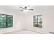 Bedroom featuring two windows with leafy views and neutral carpet at 3852 Vinyard Ne Ct, Marietta, GA 30062