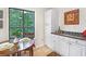 Bright breakfast nook area with dark wood table and decorative accents at 3852 Vinyard Ne Ct, Marietta, GA 30062