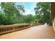 Large wooden deck featuring white deck chairs and a wooded backyard at 3852 Vinyard Ne Ct, Marietta, GA 30062