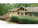 Back exterior view of a home showing the stained deck with stairs, and an abundance of trees surrounding the property at 3852 Vinyard Ne Ct, Marietta, GA 30062