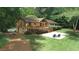 Home exterior highlighting the back of the property with a large deck and expansive yard at 3852 Vinyard Ne Ct, Marietta, GA 30062