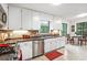 Bright kitchen with white cabinets, stainless steel appliances, and a breakfast nook overlooking the backyard at 3852 Vinyard Ne Ct, Marietta, GA 30062