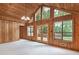 Bright living room with wood paneled walls, vaulted ceiling, and many windows overlooking trees at 3852 Vinyard Ne Ct, Marietta, GA 30062