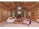 Charming living room with wood paneled walls, vaulted ceilings, a stone fireplace and comfortable seating at 3852 Vinyard Ne Ct, Marietta, GA 30062