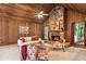 Bright living room with wood paneled walls, vaulted ceilings, a stone fireplace and comfortable seating at 3852 Vinyard Ne Ct, Marietta, GA 30062
