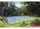 Well-maintained tennis courts surrounded by lush greenery, offering a recreational amenity at 3852 Vinyard Ne Ct, Marietta, GA 30062