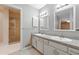 Bright bathroom featuring a double sink vanity, and a glass shower at 4477 Village Dr, Atlanta, GA 30338