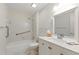 Bright bathroom featuring a tub-shower combination, vanity, and accessibility features for added comfort at 4477 Village Dr, Atlanta, GA 30338
