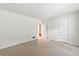 Spacious bedroom with neutral walls, carpet flooring, and an adjacent door for easy access at 4477 Village Dr, Atlanta, GA 30338