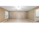Spacious bedroom featuring a ceiling fan and large windows for natural light, and neutral walls at 4477 Village Dr, Atlanta, GA 30338