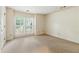Bright bedroom featuring a large window, neutral carpet, and ample space for furniture arrangement at 4477 Village Dr, Atlanta, GA 30338