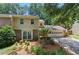 Two-story home featuring brick and siding, a two-car garage, and a well-manicured lawn at 4477 Village Dr, Atlanta, GA 30338
