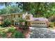 Two-story home featuring brick and siding, a two-car garage, and a well-manicured lawn at 4477 Village Dr, Atlanta, GA 30338