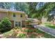 Attractive two-story home with neutral siding, brick accents, mature landscaping, and a two-car garage at 4477 Village Dr, Atlanta, GA 30338