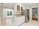 Elegant kitchen with stainless steel refrigerator and granite countertops, flowing into the sunlit living area at 4477 Village Dr, Atlanta, GA 30338
