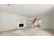 Spacious carpeted living room with fireplace, stairs, and natural light from large windows and doorways at 4477 Village Dr, Atlanta, GA 30338