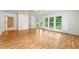 Spacious sunroom featuring hardwood floors, a ceiling fan, and white paneled walls with built in cabinets and exterior access at 4477 Village Dr, Atlanta, GA 30338