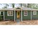 Charming green home with a welcoming yellow front door and well-manicured yard at 720 Maynard Se Ter, Atlanta, GA 30316