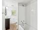 Clean bathroom with a bathtub, tiled walls, vanity, and window at 1365 Athens Sw Ave, Atlanta, GA 30310