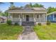 Charming home featuring a covered front porch and a well-maintained lawn at 1365 Athens Sw Ave, Atlanta, GA 30310