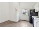 Bright kitchen features tile floor, white cabinetry, and a fire extinguisher at 1365 Athens Sw Ave, Atlanta, GA 30310