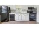 Kitchen with tile flooring, white cabinets and black appliances at 1365 Athens Sw Ave, Atlanta, GA 30310