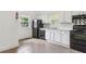 Bright kitchen features tile floor, white cabinetry, and black appliances at 1365 Athens Sw Ave, Atlanta, GA 30310