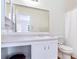 Bright bathroom featuring a spacious vanity, large mirror, and a classic white toilet and shower with curtain at 306 Autumn Leaf Way, Norcross, GA 30093