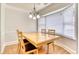 Bright dining room with a chandelier and large windows offering natural light at 306 Autumn Leaf Way, Norcross, GA 30093
